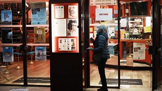 A woman wears a facemask outside a cinema in Paris.