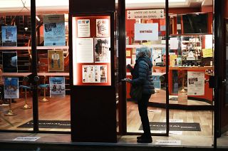 A woman wears a facemask outside a cinema in Paris.