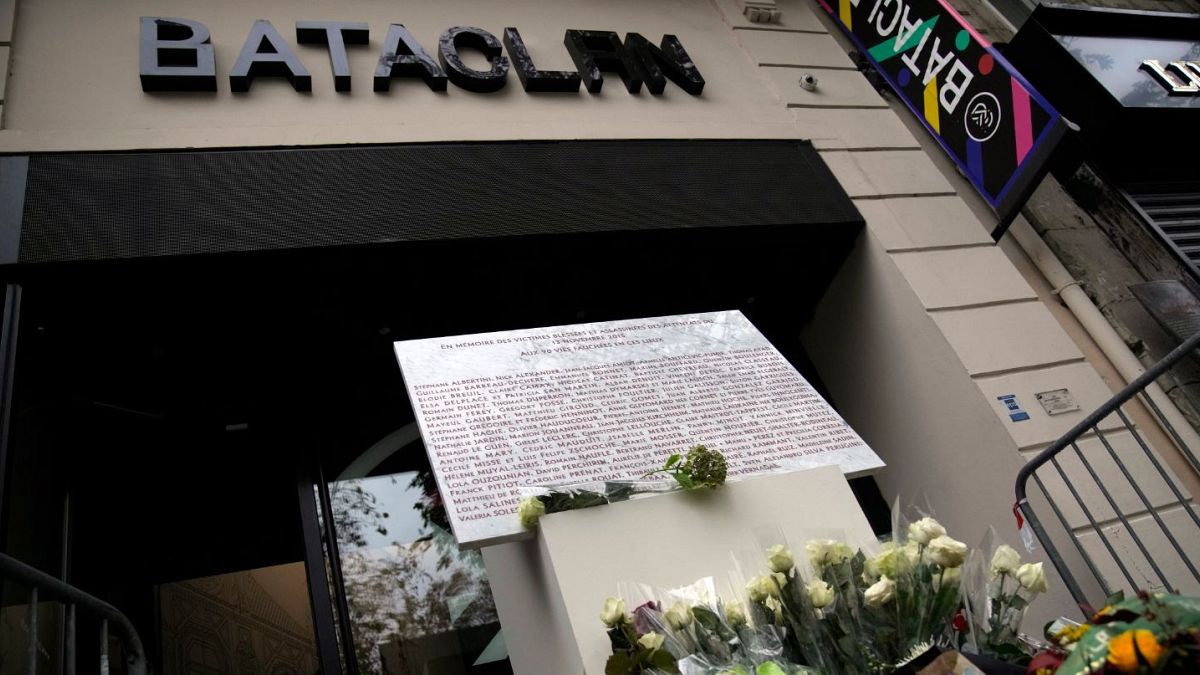 A commemorative plaque and flowers in front of the Bataclan concert hall on the sixth anniversary of the Paris attacks.