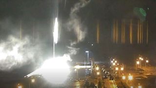This image made from a video released by Zaporizhzhia nuclear power plant shows bright flaring object landing in grounds of the plant in Enerhodar, Ukraine, 4 March 2022