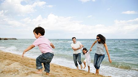 A family play on the beach