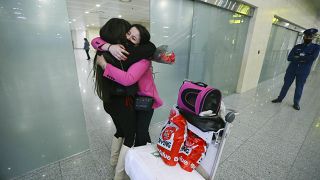 An Algerian student studying in Ukraine is embraced by a family member as she arrives at Algiers airport on a repatriation flight afer leaving Ukraine, in Algiers, Algeria,