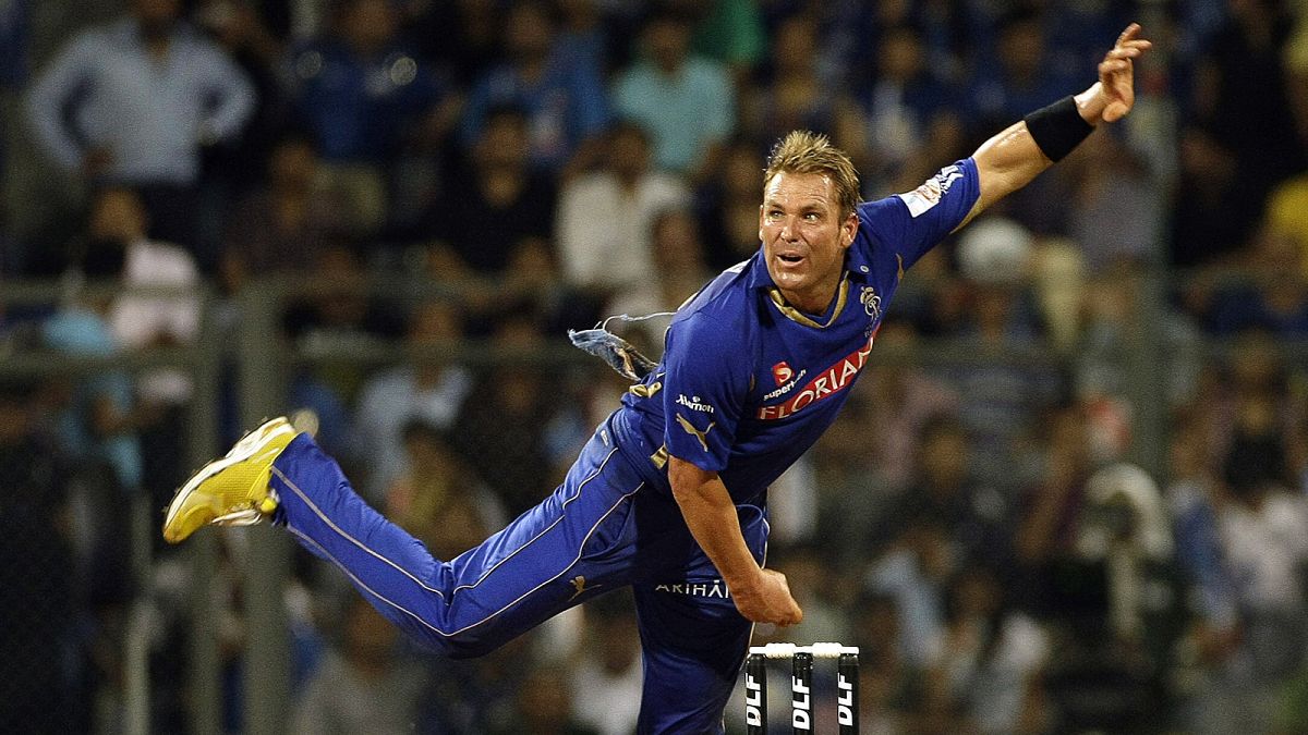 Shane Warne bowls during an Indian Premier League (IPL) cricket match in 2011