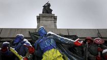 Figures part of monument of the Soviet army were painted in Ukrainian flag's colors in Sofia, Monday, Feb. 28, 2022.