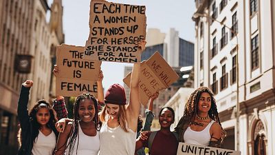 Women hold placards Women hold placards