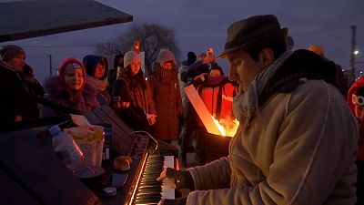 Davide Martello, Italian musician, playing piano for refugees at Polish-Ukraine border.