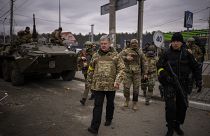 Former Ukrainian President Petro Poroshenko surrounded by Ukrainian soldiers arrives at a defence position on the outskirts of Kyiv, Ukraine, Saturday, March 5, 2022