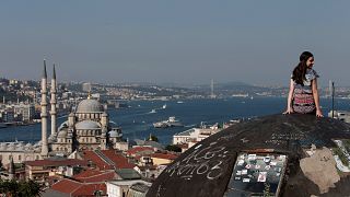 Yeni Cami ve Boğaz'a karşı poz veren bir turist / İstanbul (arşiv)
