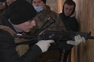 A volunteer in Lviv, Ukraine learning how to fire a gun.