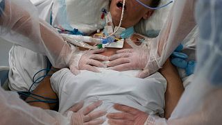 FILE - Nurses perform timed breathing exercises on a COVID-19 patient on a ventilator in the COVID-19 intensive care unit at the la Timone hospital in Marseille, December 2021