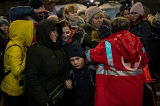 Displaced Ukrainians queue to board a bus to Poland outside Lviv train station in western Ukraine on Saturday, March 5, 2022.
