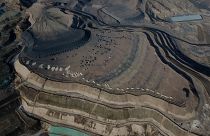 This aerial view shows coal being loaded onto trucks near a coal mine in Datong, China's northern Shanxi province, 2021.