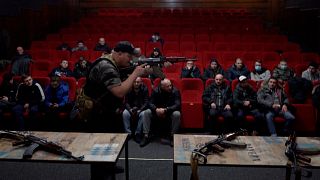 Pavlo Ganovskyi teaches civilians how to use AK47 rifles.