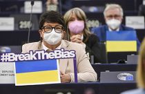 Members of European Parliament sits by Ukraine flags during a speech to mark International Women's Day, Tuesday, March 8, 2022 in Strasbourg, eastern France.