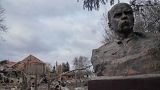 A bust of Taras Shevchenko, Ukrainian poet and national symbol, stands against the background of a runined house of culture in Byshiv, 40 kilometres west of Kyiv