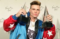 Vanilla Ice displays his awards he won in the rock and rap catagories at the American Music Awards in Los Angeles, Calif., on Jan. 28, 1991
