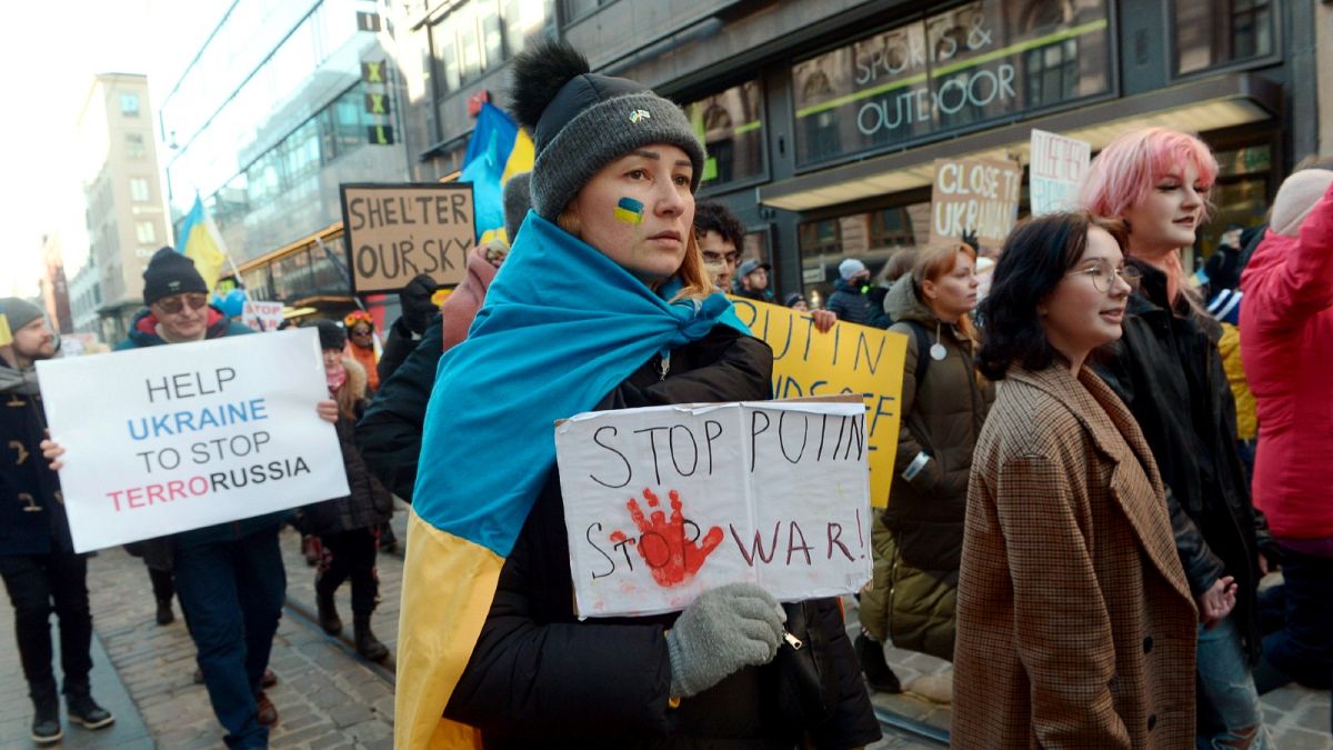 People hold banners and Ukrainian flags during a protest against the Russia invasion, in Helsinki, Saturday, March 5, 2022