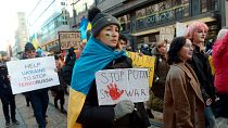 People hold banners and Ukrainian flags during a protest against the Russia invasion, in Helsinki, Saturday, March 5, 2022 People hold banners and Ukrainian flags during a protest against the Russia invasion, in Helsinki, Saturday, March 5, 2022