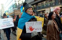 People hold banners and Ukrainian flags during a protest against the Russia invasion, in Helsinki, Saturday, March 5, 2022