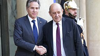 U.S. Secretary of State Antony Blinken, left, is welcomed by French Foreign Minister Jean-Yves le Drian in the courtyard of the Elysee Palace