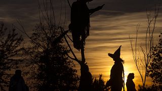 A visitor in a witch's hat during Halloween in Leipzig, eastern Germany.