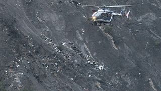 A rescue helicopter flies over debris of the Germanwings Airbus A320-211 near Seyne-les-Alpes.