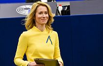 Estonian Prime Minister Kaja Kallas, wearing a dress and a ribbon under the colors of Ukraine, arrives to deliver a speech during a debate on EU's role.