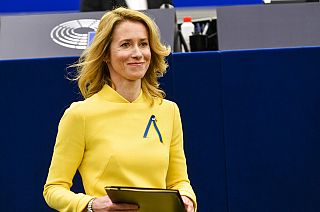 Estonian Prime Minister Kaja Kallas, wearing a dress and a ribbon under the colors of Ukraine, arrives to deliver a speech during a debate on EU's role.