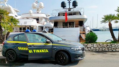 An Italian Financial Police car is parked in front of the superyacht “Lena", belonging to Gennady Timchenko.