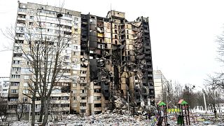This picture shows an apartment building damaged after shelling the day before in Ukraine's second-biggest city of Kharkiv on March 8, 2022.