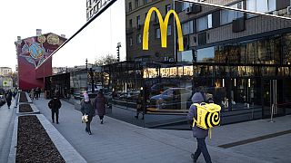 People walk past a McDonald's restaurant in the main street in Moscow