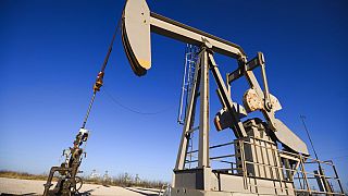 A pumpjack operates just outside of the Odessa Ector Power Partners natural gas power plant