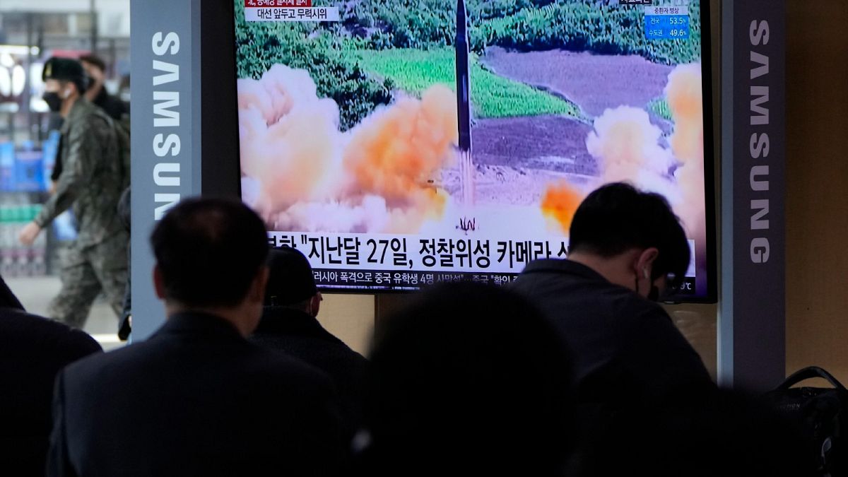 People watch a TV showing a file image of North Korea's missile launch during a news program at the Seoul Railway Station in Seoul, South Korea, March 5, 2022. 