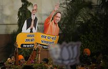 Bharatiya Janata Party supporters hold cuts outs of Indian prime minister Narendra Modi and Uttar Pradesh Chief minister Yogi Adityanath