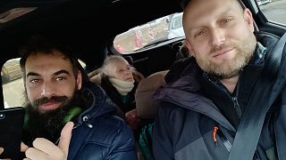 Daniele, right, during his return trip to the Poland-Ukraine border. A Ukrainian refugee, 84, sits in the back.