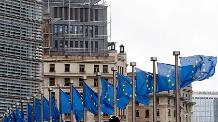 File: European Union flags outside EU headquarters in Brussels