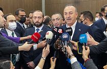 Turkey's Foreign Minister Mevlut Cavusoglu talks to journalists next to his Armenia counterpart Ararat Mirzoyan after their meeting
