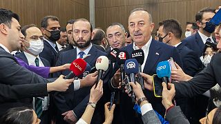 Turkey's Foreign Minister Mevlut Cavusoglu talks to journalists next to his Armenia counterpart Ararat Mirzoyan after their meeting