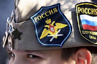 A boy wears Russian insignia on his hat as he rallies in Banjaluka, Bosnia, Saturday, 12 March 2022