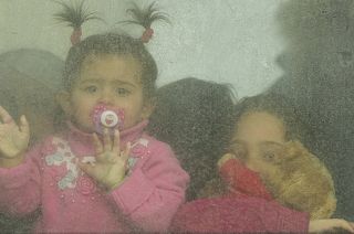 Refugee children look out from a bus leaving to Romania after fleeing the war from neighbouring Ukraine in Palanca, Moldova