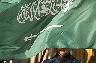 A US Honor Guard member is covered by the flag of Saudi Arabia as Defence Secretary Jim Mattis welcomes Saudi Crown Prince Mohammed bin Salman to the Pentagon in 2019.
