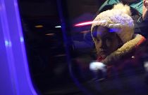 Refugees that fled the war in Ukraine sit in a car outside the train station in Przemysl, southeastern Poland