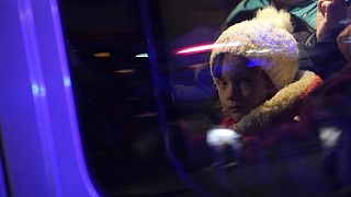 Refugees that fled the war in Ukraine sit in a car outside the train station in Przemysl, southeastern Poland