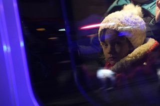 Refugees that fled the war in Ukraine sit in a car outside the train station in Przemysl, southeastern Poland