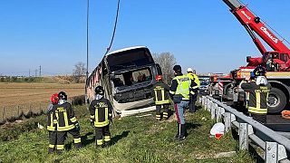 Police and rescue services attend the scene of a bus crash near Forli, Italy