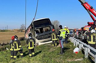 Police and rescue services attend the scene of a bus crash near Forli, Italy
