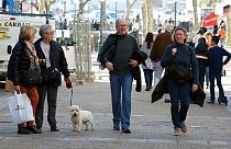People not wearing face masks walk in Saint-Jean-de-Luz southwestern France