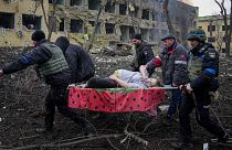 Ukrainian emergency employees and volunteers carry an injured pregnant woman from a maternity hospital that was damaged by shelling in Mariupol, Ukraine, March 9, 2022.