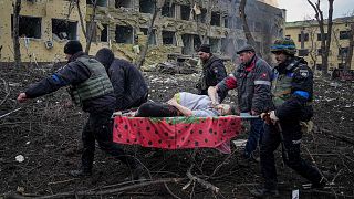 Ukrainian emergency employees and volunteers carry an injured pregnant woman from a maternity hospital that was damaged by shelling in Mariupol, Ukraine, March 9, 2022.