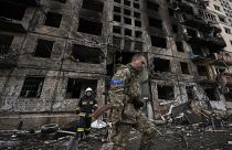 Ukrainian soldiers and firefighters search in a destroyed building after a bombing attack in Kyiv, Ukraine, Monday, March 14, 2022. 
